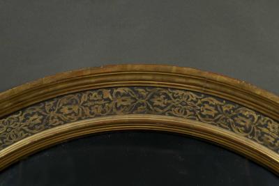 A Renaissance Revival Ebonized and Parcel Gilt Circular Convex Mirror