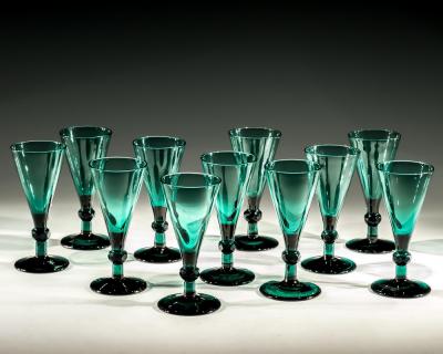 A SET OF ELEVEN GREEN WINE GLASSES