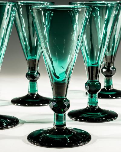 A SET OF ELEVEN GREEN WINE GLASSES