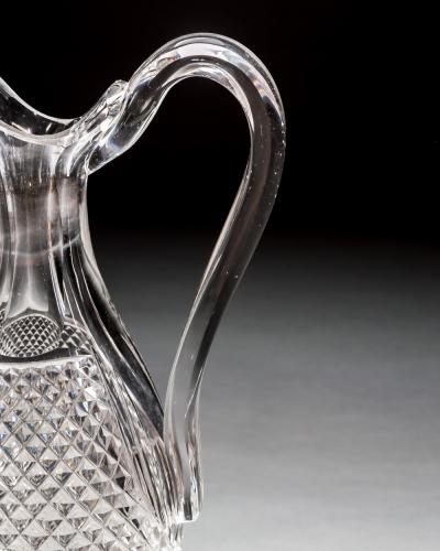 A SET OF FOUR DIAMOND SWIRL CUT DECANTERS WITH CORRESPONDING WINE EWER