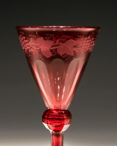 A SET OF FOUR RED ENGRAVED WINE GLASSES
