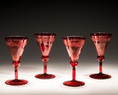 A SET OF FOUR RED ENGRAVED WINE GLASSES