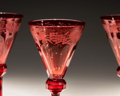 A SET OF FOUR RED ENGRAVED WINE GLASSES