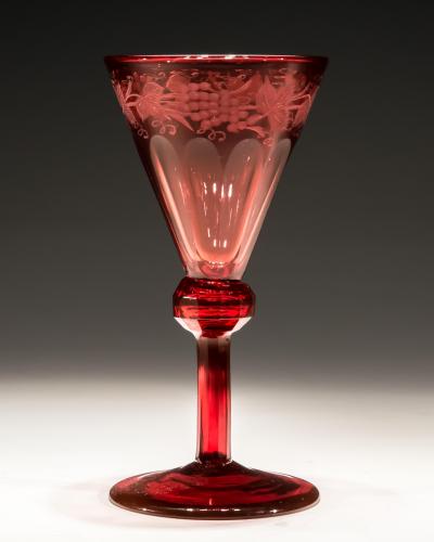 A SET OF FOUR RED ENGRAVED WINE GLASSES