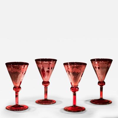 A SET OF FOUR RED ENGRAVED WINE GLASSES