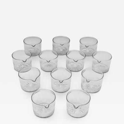 A SET OF TWELVE FLUTE CUT FINGER BOWLS WITH A STAR CUT BASE