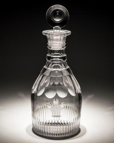 A SLICE AND FLUTE CUT GLASS GEORGIAN SPIRIT DECANTER