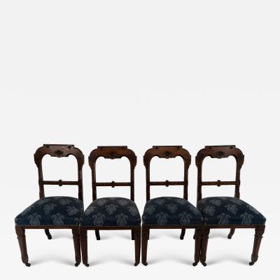 A Set of Four Aesthetic Movement Oak Dining Chairs with Carved Decoration