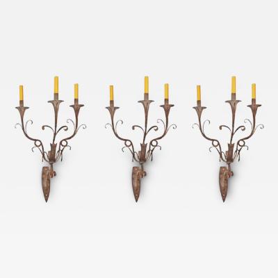 A Set of Three Italian Wrought Iron Sconces