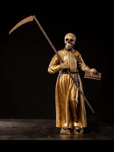 A South German polychromed and gilt wood figure of a Monastic Poor Soul 