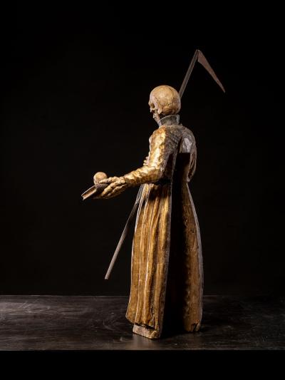 A South German polychromed and gilt wood figure of a Monastic Poor Soul 