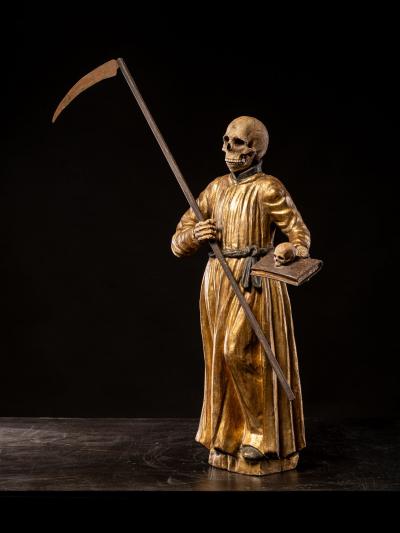 A South German polychromed and gilt wood figure of a Monastic Poor Soul 