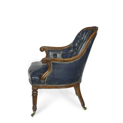 A Victorian blue leather oak library chair