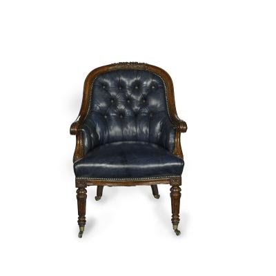 A Victorian blue leather oak library chair