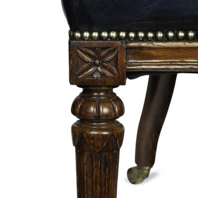 A Victorian blue leather oak library chair