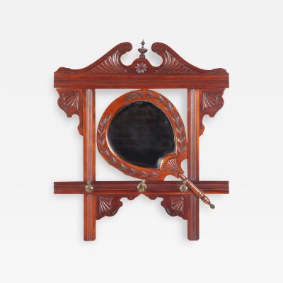 A Victorian carved mahogany wall mirror with shaped beveled mirror circa 1880 