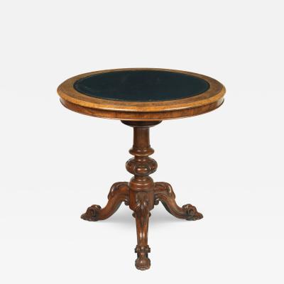 A Victorian walnut revolving display table