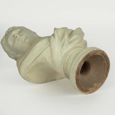 A Victorian white painted terracotta bust of a young woman