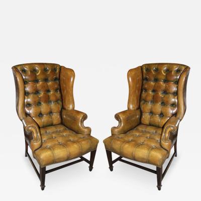 A Vintage Pair of Tufted Leather Wing Chairs