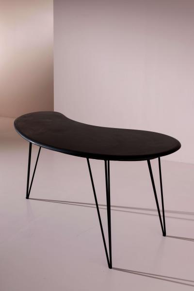 A bean shaped table made of dark slate and iron Italy late 1950s