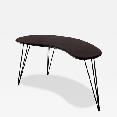 A bean shaped table made of dark slate and iron Italy late 1950s