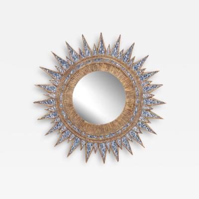 A blue textured glass and resin star form mirror in the manner of Line Vautrin 