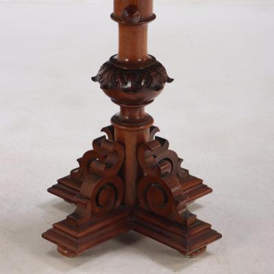 A carved walnut adjustable pedestal table 19th C