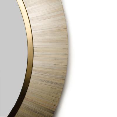 A contemporary modernist round mirror executed in meticulous straw marquetry 