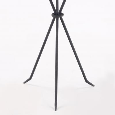 A contemporary pair of wrought iron drink tables having ring decoration 