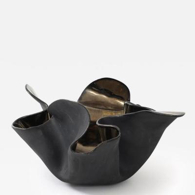 A decorative free form organic bowls in a highly reflective platinum finish