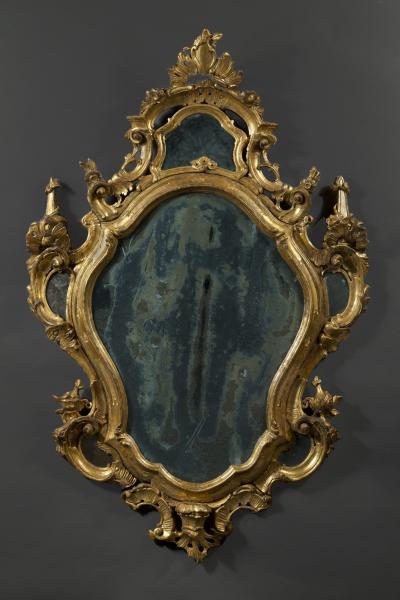 A fine pair of barocchetto escutcheon shaped giltwood mirrors cum girandoles