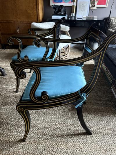 A fine pair of caned Regency ebonized and gilt chairs