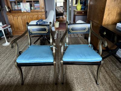 A fine pair of caned Regency ebonized and gilt chairs