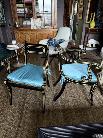 A fine pair of caned Regency ebonized and gilt chairs