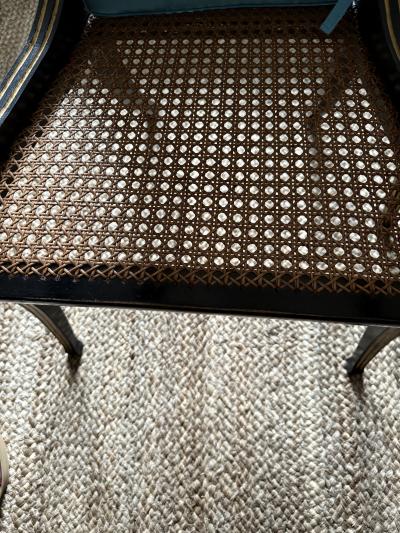 A fine pair of caned Regency ebonized and gilt chairs
