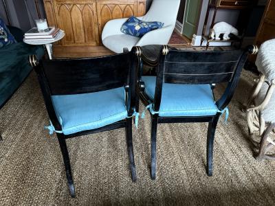 A fine pair of caned Regency ebonized and gilt chairs