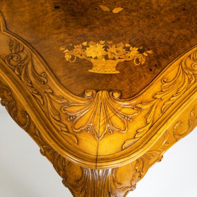A fine walnut and burr walnut Orientalist centre table