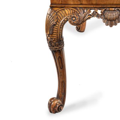 A finely carved walnut side table in the George II style