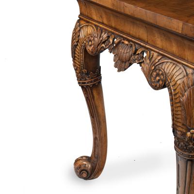 A finely carved walnut side table in the George II style