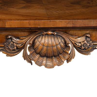 A finely carved walnut side table in the George II style