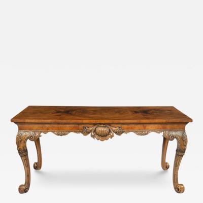 A finely carved walnut side table in the George II style