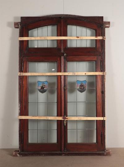 A four panel mahogany window set in frame with leaded glass having ship motif 