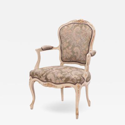 A gilt and painted French upholstered open armchair in the Louis XV style 