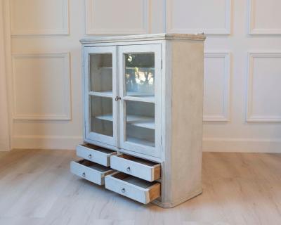 A hanging cabinet from Sweden with glass doors in grey