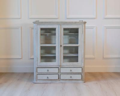 A hanging cabinet from Sweden with glass doors in grey