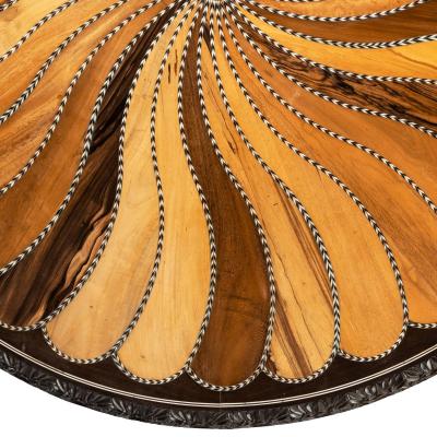 A large Anglo Ceylonese ebony and specimen wood centre table circa 1840