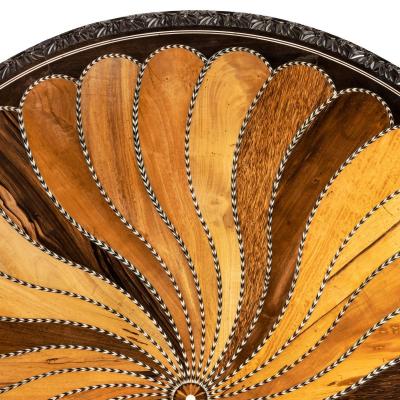 A large Anglo Ceylonese ebony and specimen wood centre table circa 1840