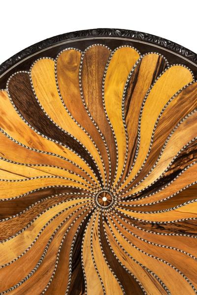 A large Anglo Ceylonese ebony and specimen wood centre table circa 1840