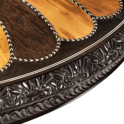 A large Anglo Ceylonese ebony and specimen wood centre table circa 1840