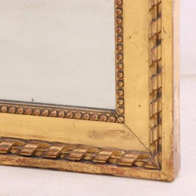 A large French Neoclassical Revival giltwood mirror with ribbon crest C 1890 